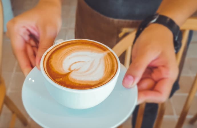 Lady holding a cup of warm coffee