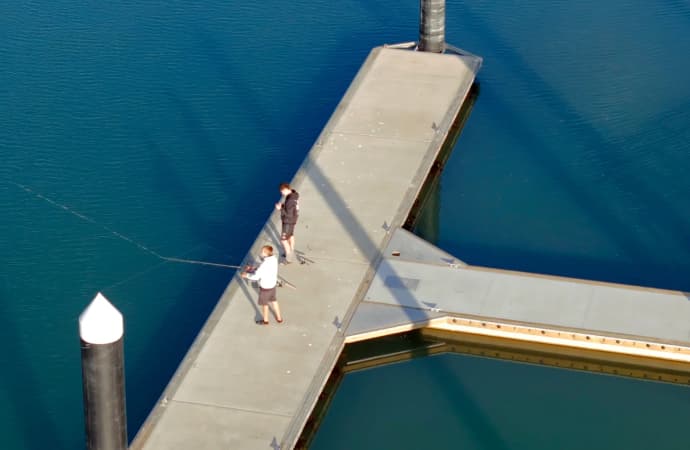 2 men fishing from Weiti Waterfront Pier